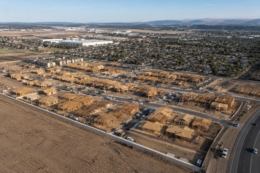 Aerial view of a large residential framing project with multiple homes under construction for production builders